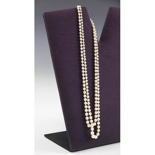 148 - An early 20th century pearl necklace with diamond clasp, comprising two rows of graduated cultured p... 