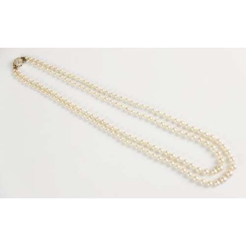 148 - An early 20th century pearl necklace with diamond clasp, comprising two rows of graduated cultured p... 