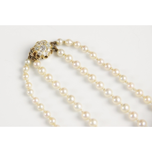 148 - An early 20th century pearl necklace with diamond clasp, comprising two rows of graduated cultured p... 