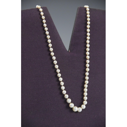 149 - A pearl necklace with a 9ct gold diamond set clasp, designed as a single row of round cultured pearl... 