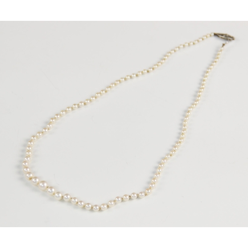 149 - A pearl necklace with a 9ct gold diamond set clasp, designed as a single row of round cultured pearl... 