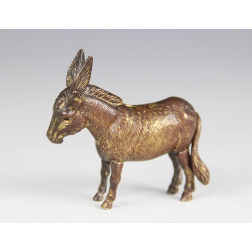 180 - A late 19th century novelty brass tape measure, modelled as a donkey with fur effect chasing, articu... 