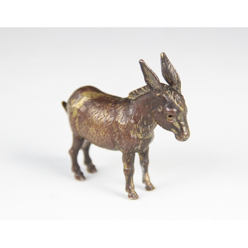 180 - A late 19th century novelty brass tape measure, modelled as a donkey with fur effect chasing, articu... 