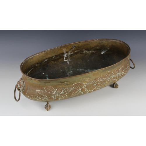 597 - A late Victorian brass planter, of oval form embossed with foliate and fruit motifs, lion mask loop ... 