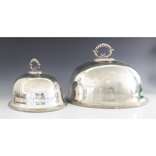 64 - Two EPNS meat covers by Martin Hall & Co, each of domed oval form with beaded borders and scrolling ... 