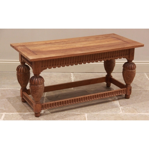 780 - A 17th century style carved golden oak side table, late 20th century, the rectangular cleated top ab... 