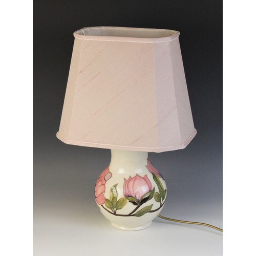 391 - A large Moorcroft table lamp, of baluster form, decorated in the pink magnolia pattern against a cre... 