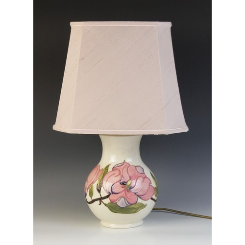 391 - A large Moorcroft table lamp, of baluster form, decorated in the pink magnolia pattern against a cre... 