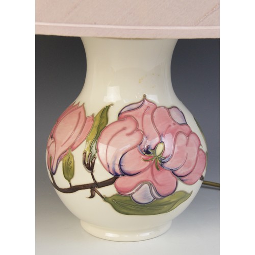 391 - A large Moorcroft table lamp, of baluster form, decorated in the pink magnolia pattern against a cre... 