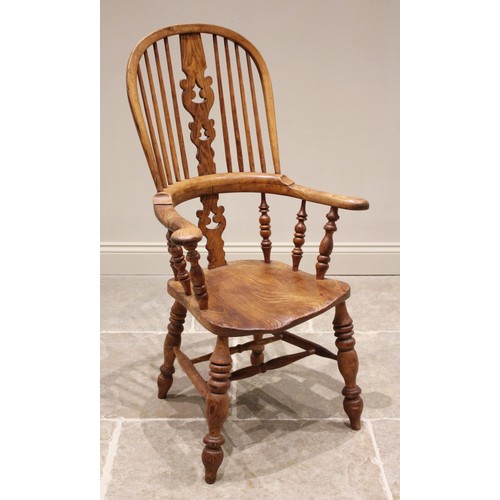 733 - A 19th century ash and elm Windsor farmhouse elbow chair, the hoop back with a central pierced splat... 