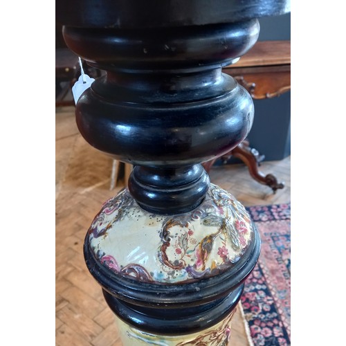 747 - An ebonised hardwood and pottery torchere, early 20th century, the square top above a turned ebonise... 