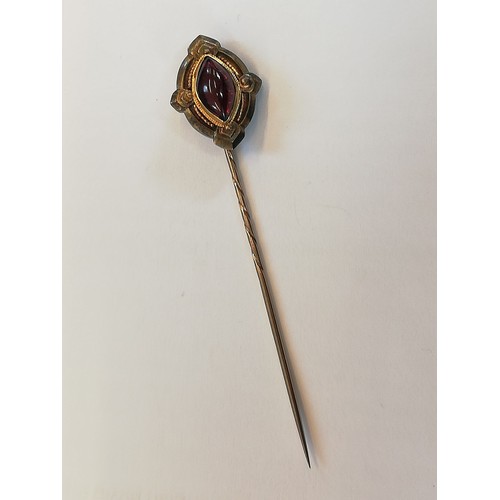 152 - A Victorian 'golden nugget' stick pin, the (untested) nugget measuring 20mm x 12mm, upon a gold colo... 