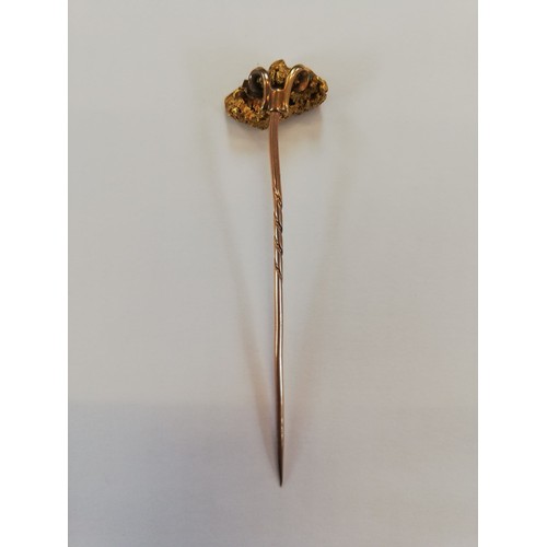 152 - A Victorian 'golden nugget' stick pin, the (untested) nugget measuring 20mm x 12mm, upon a gold colo... 