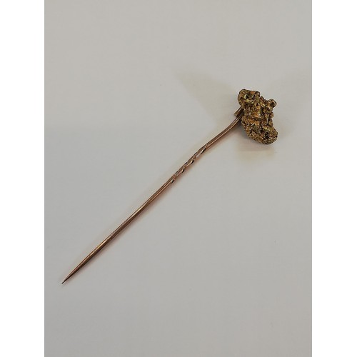 152 - A Victorian 'golden nugget' stick pin, the (untested) nugget measuring 20mm x 12mm, upon a gold colo... 