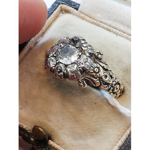 123 - A 19th century diamond floral cluster ring, comprising a central oval old cut diamond measuring 5.3m... 