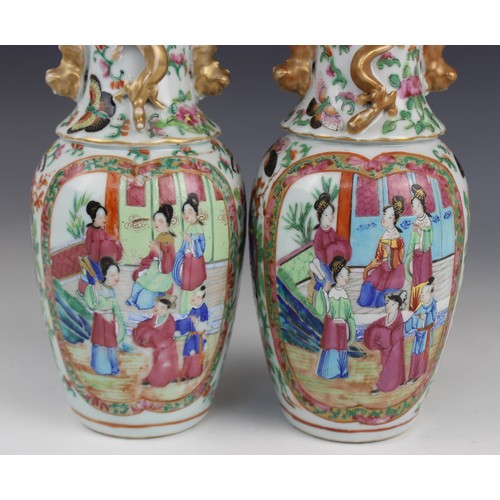 452 - A pair of Chinese Canton vases, late 19th century, each of baluster form and decorated in the famill... 