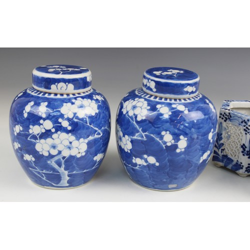 454 - A pair of Chinese porcelain blue and white prunus pattern ginger jars and covers, each of typical gl... 