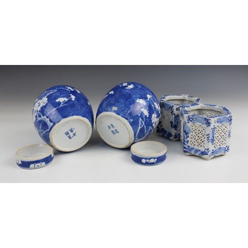 454 - A pair of Chinese porcelain blue and white prunus pattern ginger jars and covers, each of typical gl... 