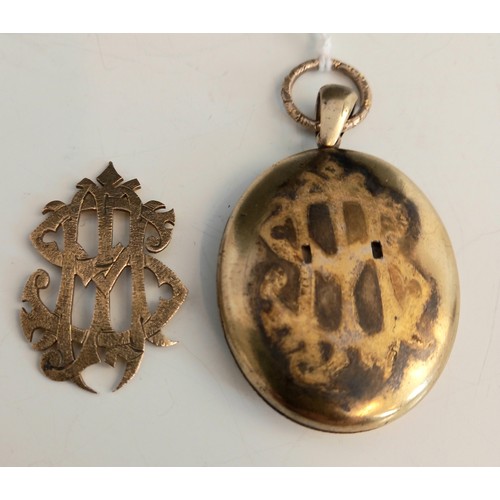 151 - A Victorian locket pendant, the unmarked gold coloured pendant of oval form, the cover with applied ... 