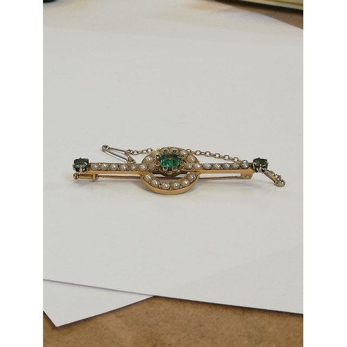 121 - A Victorian emerald, pearl and diamond brooch, the central rectangular step cut emerald measuring 5.... 