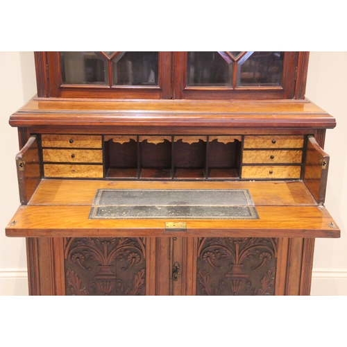 678 - A large 19th century carved walnut secretaire bookcase, the pair of bevelled astragal glazed cupboar... 