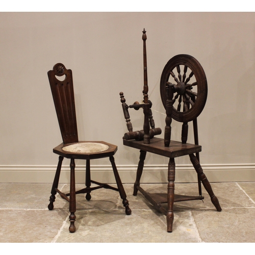 681 - An oak spinning wheel, late 19th/early 20th century, with a 40cm spindled wheel, raised upon turned ... 