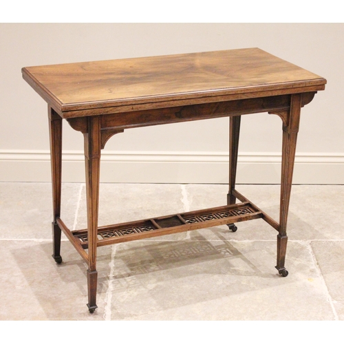 682 - A Victorian rosewood folding games table, the rectangular moulded top raised upon legs of tapering s... 