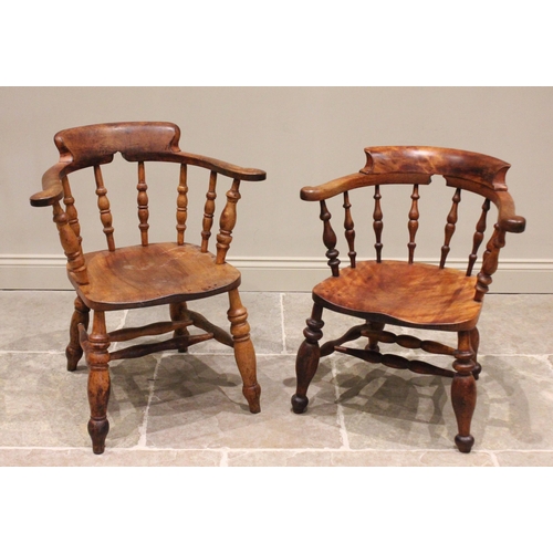 684 - Two Victorian elm and beech wood smokers bow elbow chairs, each with a horse shoe shaped top rail ab... 