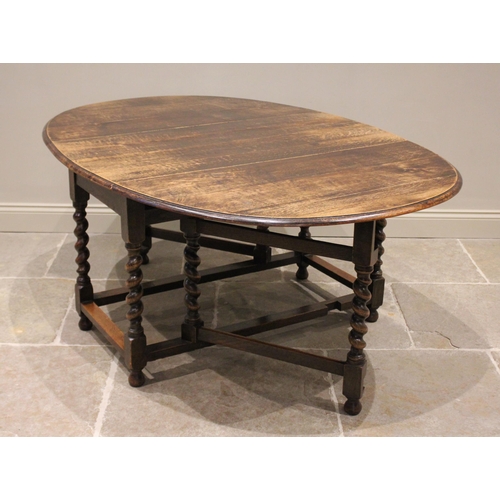 685 - A 17th century style oak drop leaf dining table, late 19th/early 20th century, the moulded oval top ... 