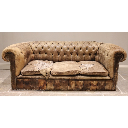 687 - A large leather upholstered Chesterfield sofa, late 19th/early 20th century, the curved button back ... 