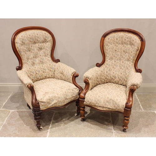 698 - A near pair of Victorian mahogany framed armchairs, each with an upholstered spoon back extending to... 