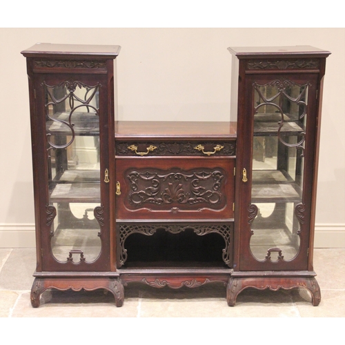 699 - A late Victorian mahogany chiffonier, the central carved frieze drawer and cupboard door flanked by ... 