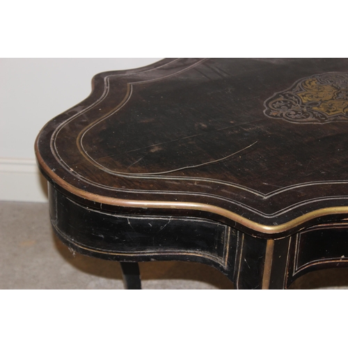 703 - A late 19th century ebonised and brass inlaid bureau plat/centre table, the serpentine shaped top ce... 