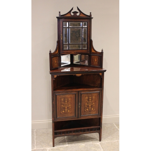 706 - A late Victorian rosewood freestanding corner display cabinet, the architectural pediment above a si... 