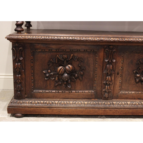 714 - A Victorian carved oak buffet, the upper tier with a pair of foliate carved frieze drawers, raised u... 