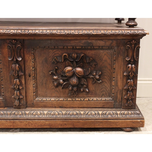 714 - A Victorian carved oak buffet, the upper tier with a pair of foliate carved frieze drawers, raised u... 