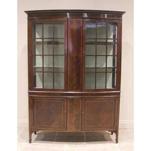 722 - An Edwardian mahogany bowfront display cabinet, the twin astragal glazed doors opening to a satin li... 