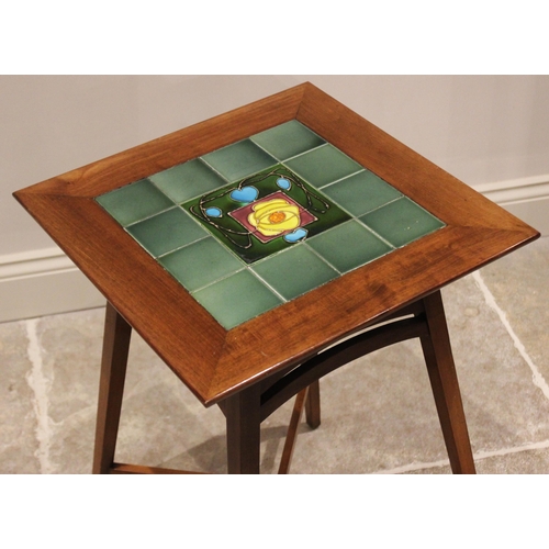 723 - A tiled top mahogany occasional table in the manner of Liberty, the square top centred with an Art N... 