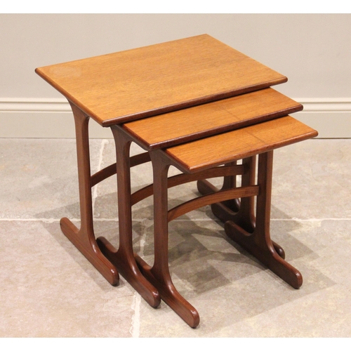 741 - A nest of three G-Plan style teak tables, mid 20th century, each raised upon trestle type supports u... 