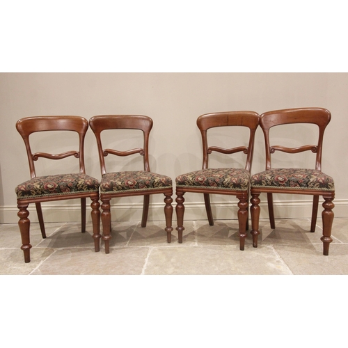 674 - A set of three late 19th century walnut dining chairs, each with foliate carved balloon backs and se... 