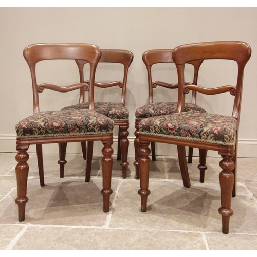 674 - A set of three late 19th century walnut dining chairs, each with foliate carved balloon backs and se... 