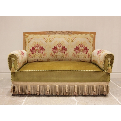 697 - A Victorian sofa, the upholstered floral tapestry back rest within a carved walnut frame, extending ... 