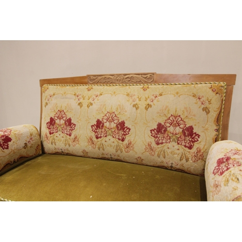 697 - A Victorian sofa, the upholstered floral tapestry back rest within a carved walnut frame, extending ... 