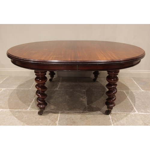 700 - A Victorian mahogany dining table, the oval moulded top raised upon substantial barley twist legs te... 