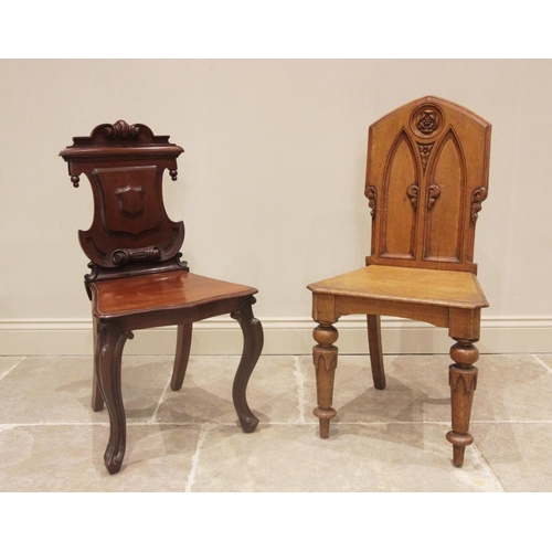 707 - A Victorian mahogany hall chair, the shield shaped back with scrolled detail above a moulded serpent... 