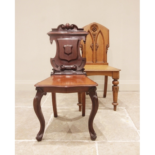 707 - A Victorian mahogany hall chair, the shield shaped back with scrolled detail above a moulded serpent... 