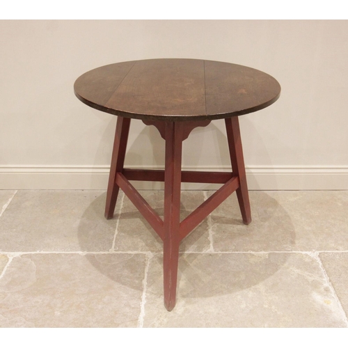 709 - A 19th century and later oak and painted cricket table, the circular oak top raised upon an associat... 