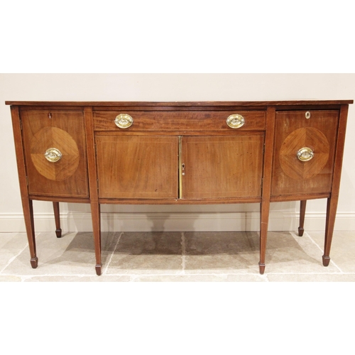 717 - A 19th century bow front mahogany sideboard, formed from a single frieze drawer over a pair of conve... 