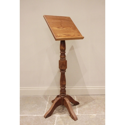 726 - An oak and beech wood lectern, late 20th century, the sloping book rest raised upon a block and balu... 