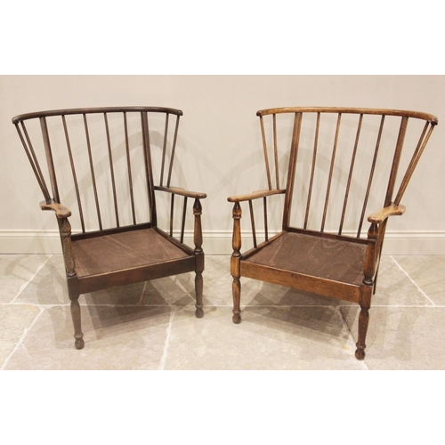 745 - A near pair of mid century Ercol style stick back beech wood open armchairs, each raised upon turned... 